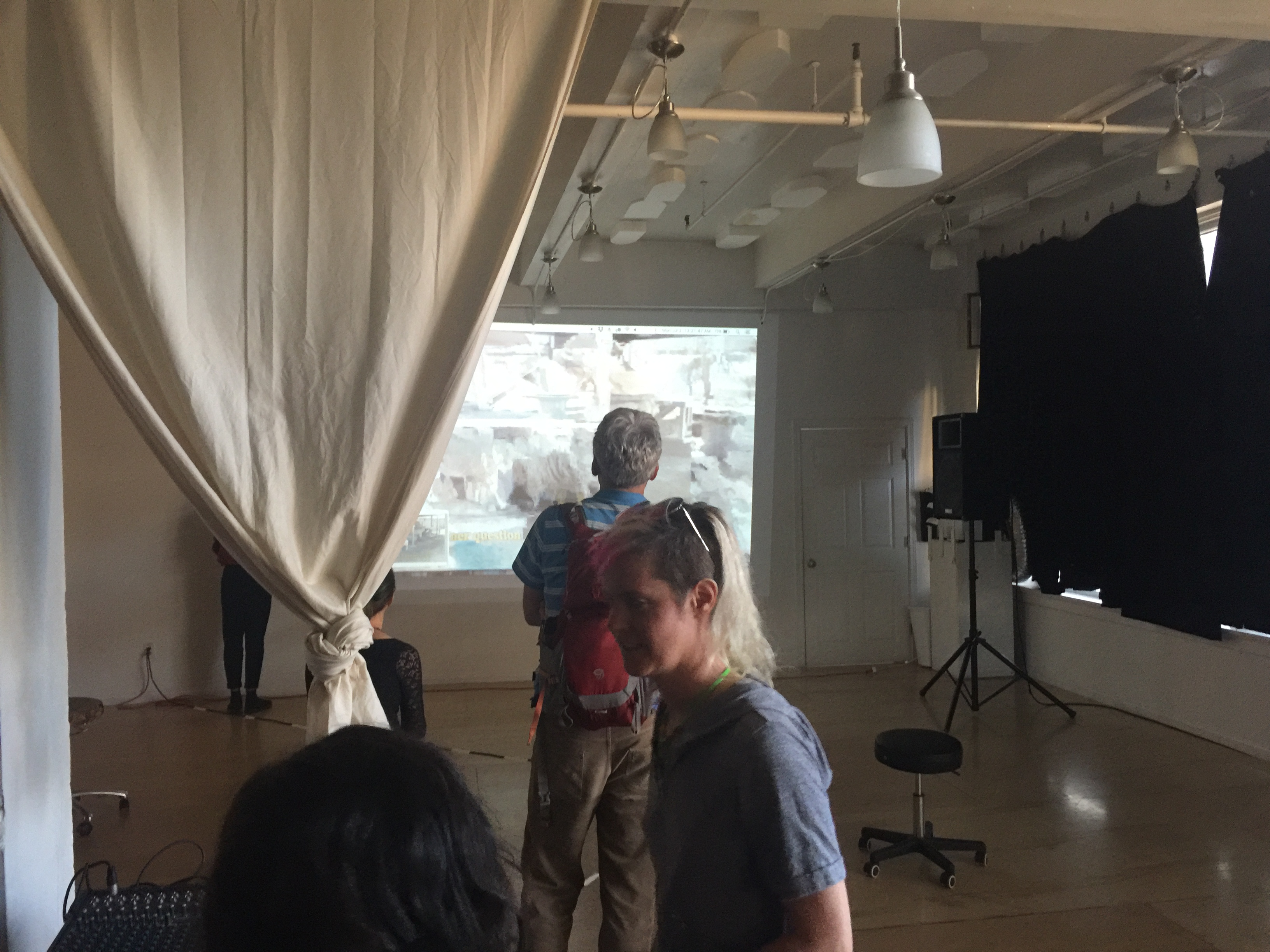 SHOUT HOUSE interior during the #cyborgs First Friday pop-up — projection screen and audience